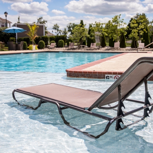 Lounge chair on the tanning ledge in the shallow area of the pool